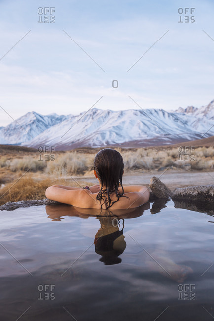 Woman enjoying hot spring in cold winter, Mammoth Lakes  Hot Spring, California, USA
