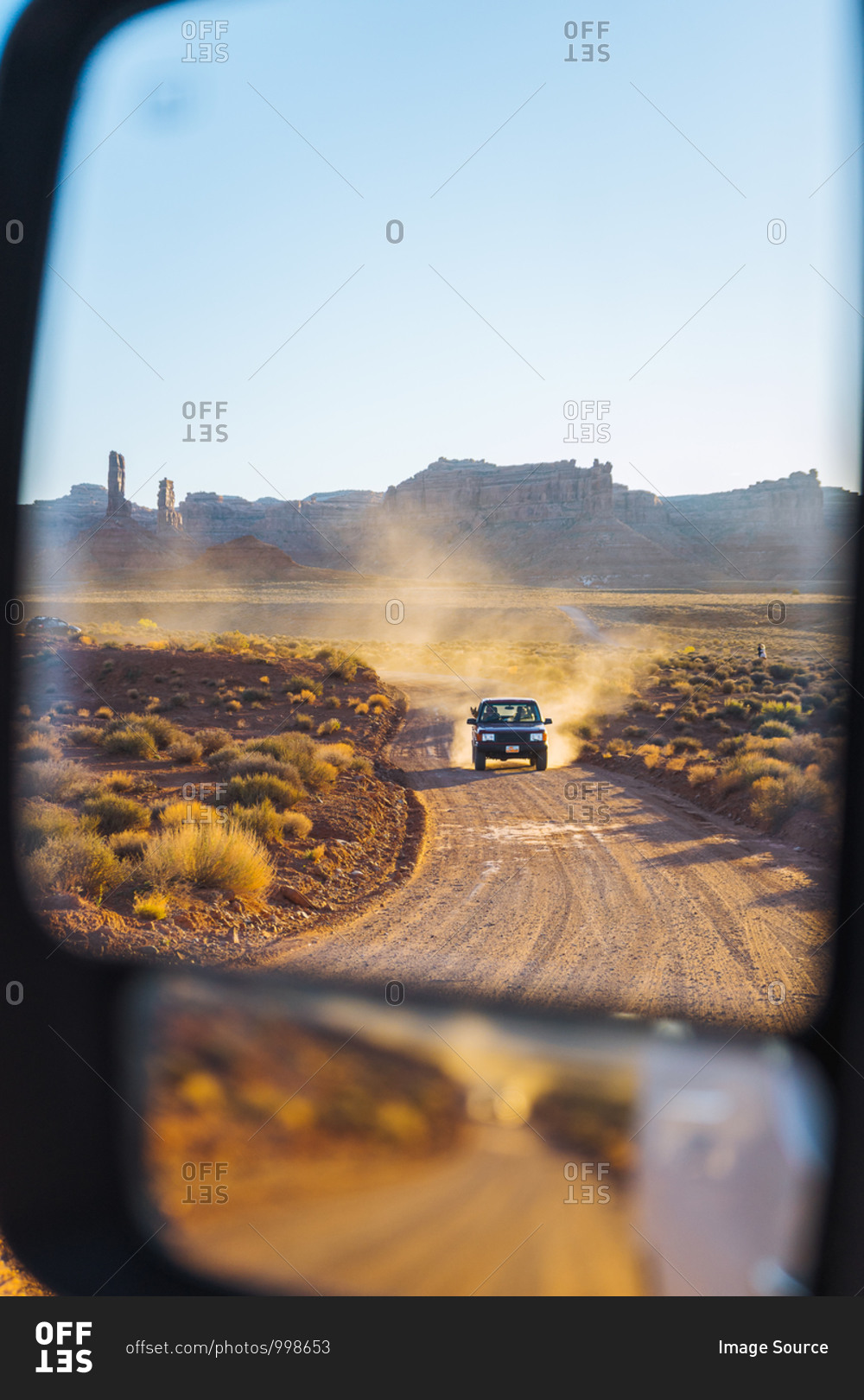 Off road vehicle driving through Valley of the Gods, Utah, US