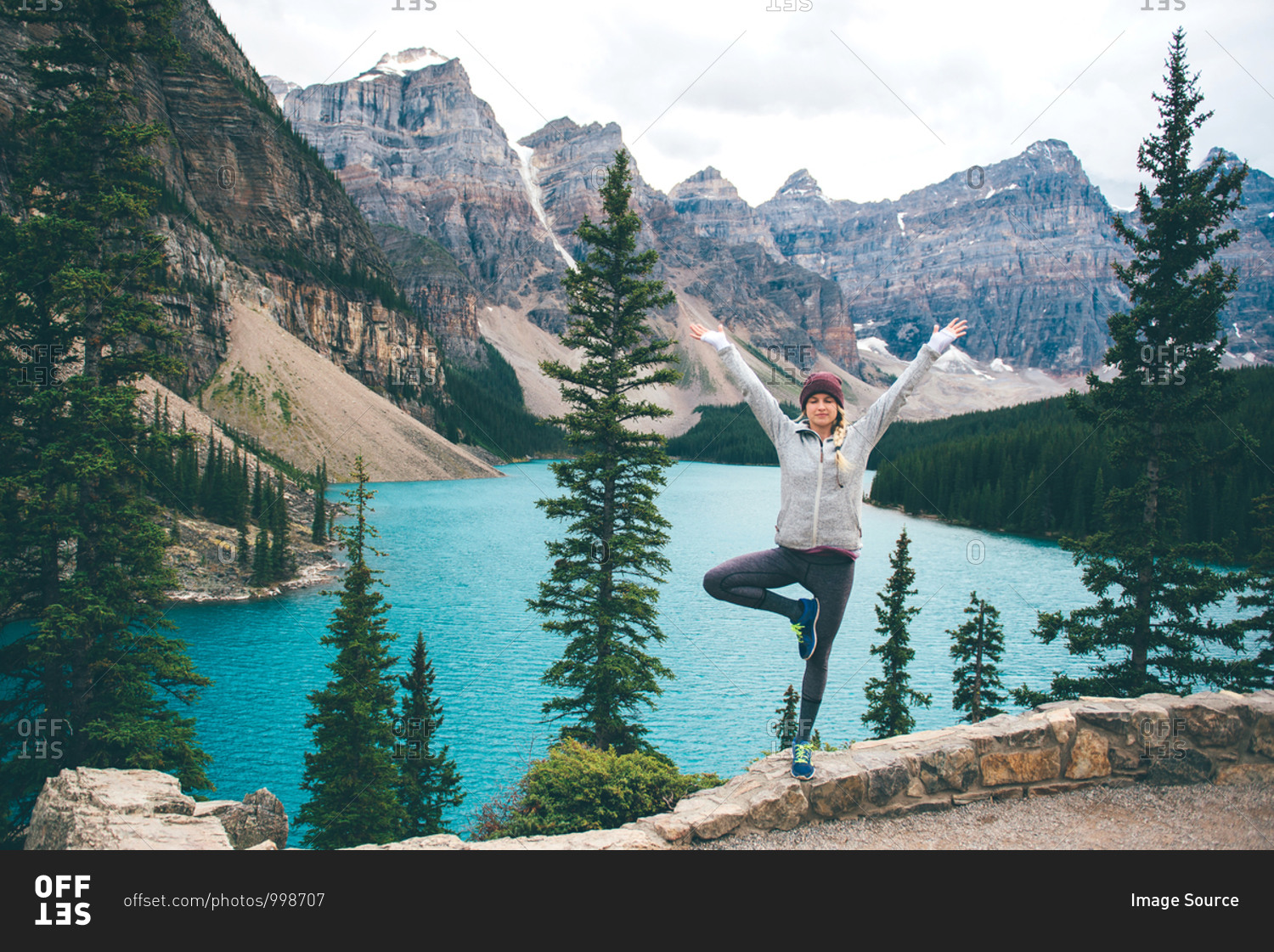 Woman practicing yoga, Moraine Lake, Banff, Canada