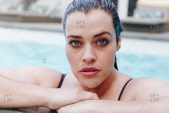 Sultry mid adult woman in outdoor swimming pool, head and shoulder portrait, Cape Town, South Africa