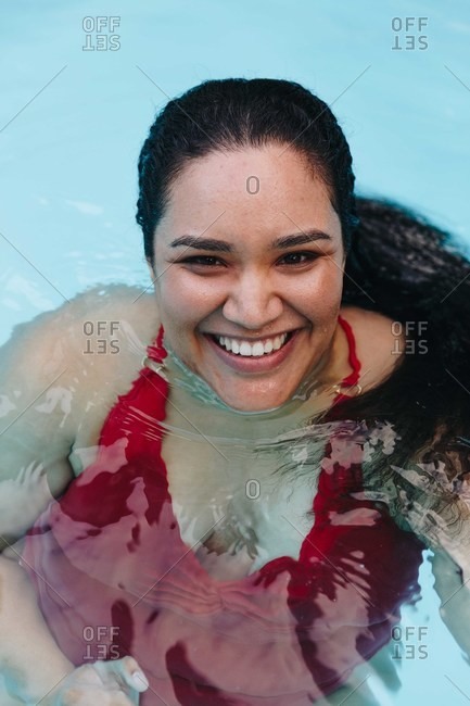 Mid adult woman with wet hair in outdoor swimming pool, portrait, Cape Town, South Africa