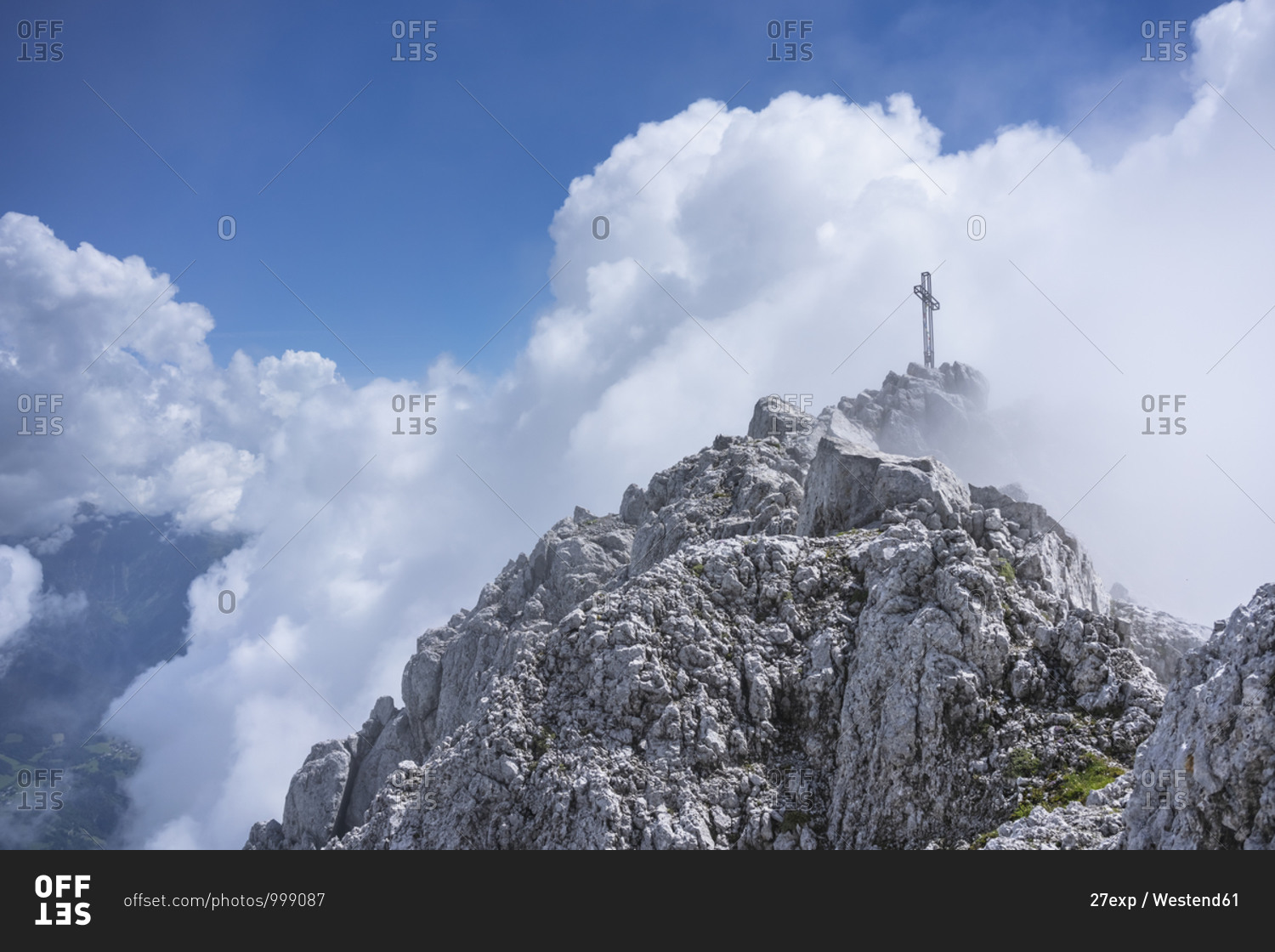 Low angle view of religious cross on mountain top against cloudy sky- Bergamasque Alps- Germany