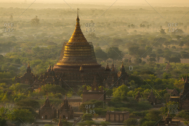 Myanmar- Mandalay Region- Bagan- Aerial view of ancient Buddhist temple at foggy dawn