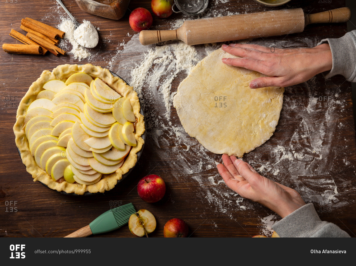 Overhead view of a baker making apple pie and rolling pin