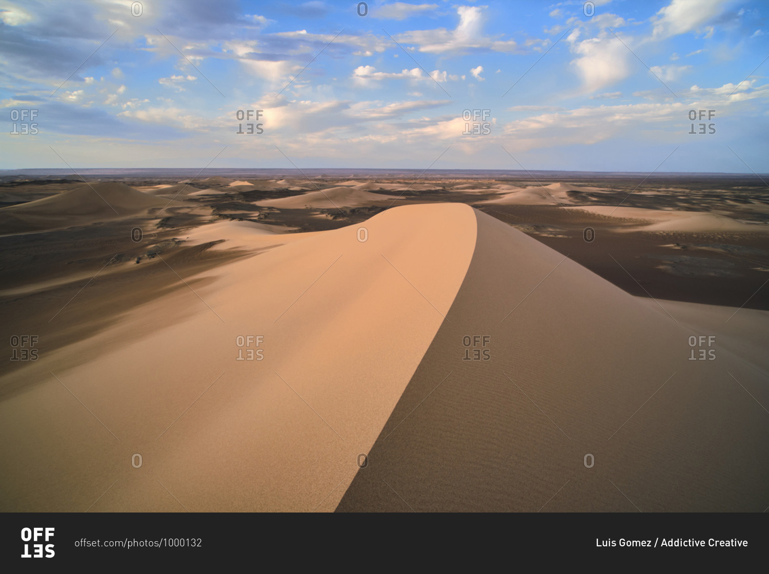 Minimalistic desert landscape with sandy dunes and clear blue sky in Hami, Xinjiang in China