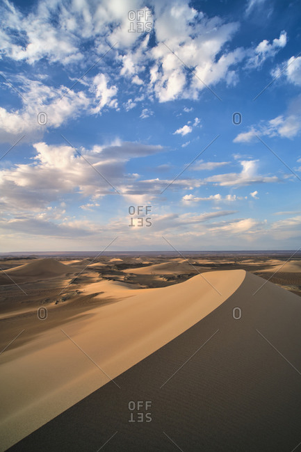 Minimalistic desert landscape with sandy dunes and clear blue sky in Hami, Xinjiang in China