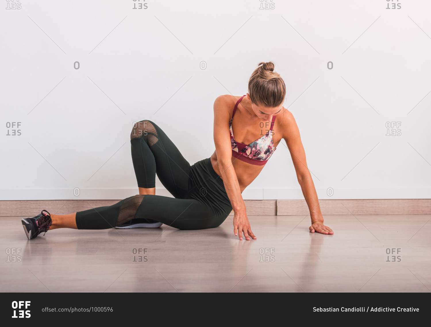 Slim woman doing pose on yoga mat stock photo - OFFSET