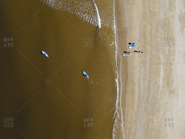 Aerial view of surfers on sandy coastal beach of Barents Sea
