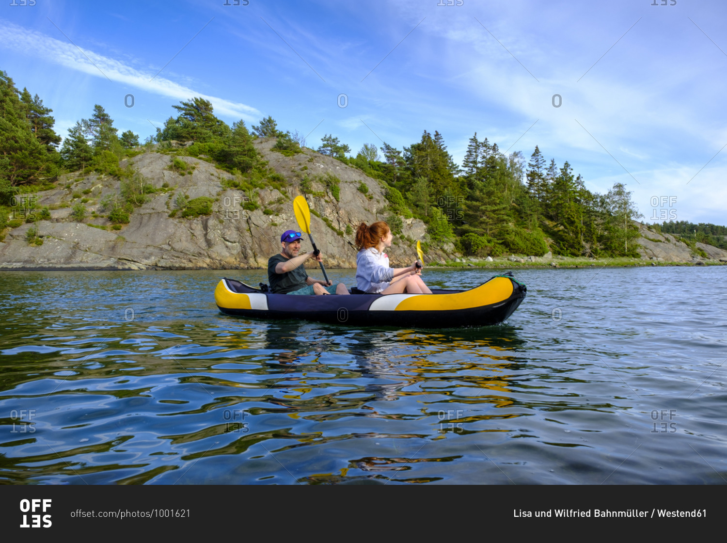 Sweden- Vastra Gotaland County- Kyrkesund- People kayaking near coast of Lilla Askeron island