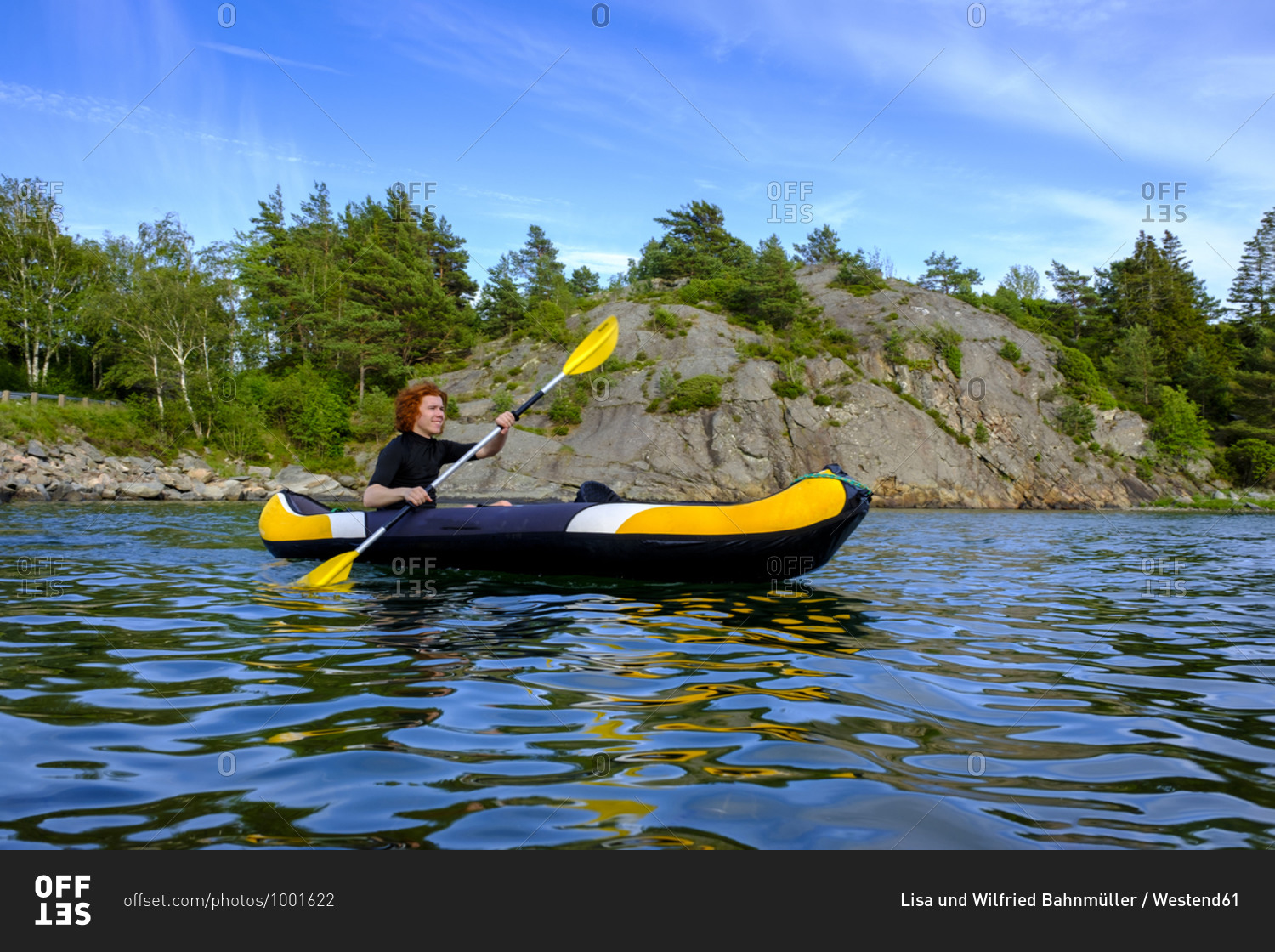 Sweden- Vastra Gotaland County- Kyrkesund- Teenage boy kayaking near coast of Lilla Askeron island