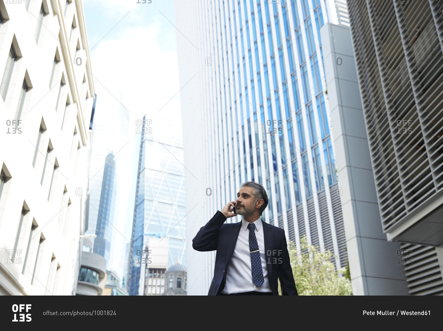 Businessman talking over mobile phone in city