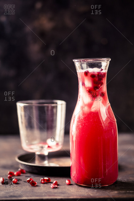 Carafe of pomegranate fizz with pomegranate juice- ice cubes and tonic water