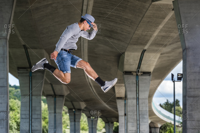 Young man doing acrobatics outdoors