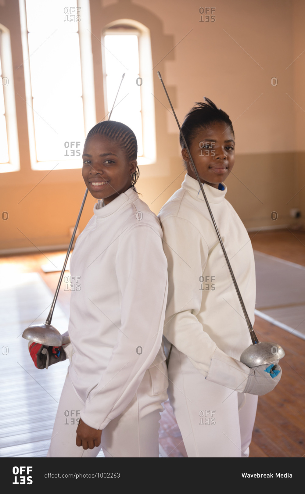 Portrait of two African American sportswomen wearing protective fencing