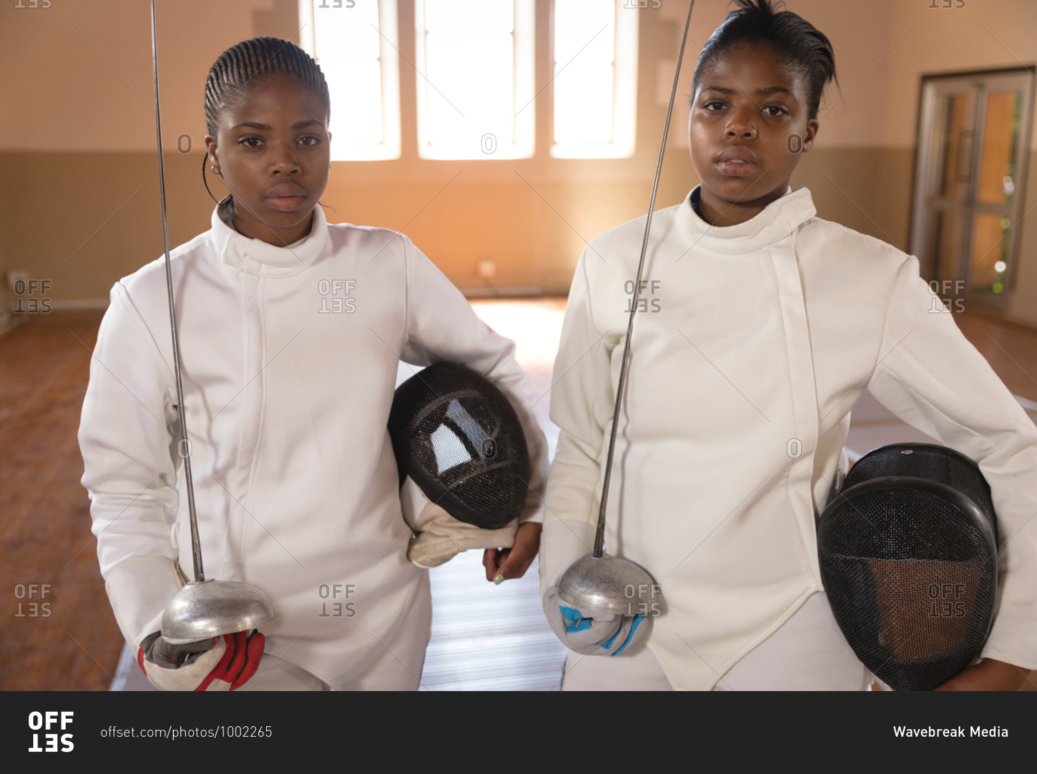 Portrait of two African American sportswomen wearing protective fencing