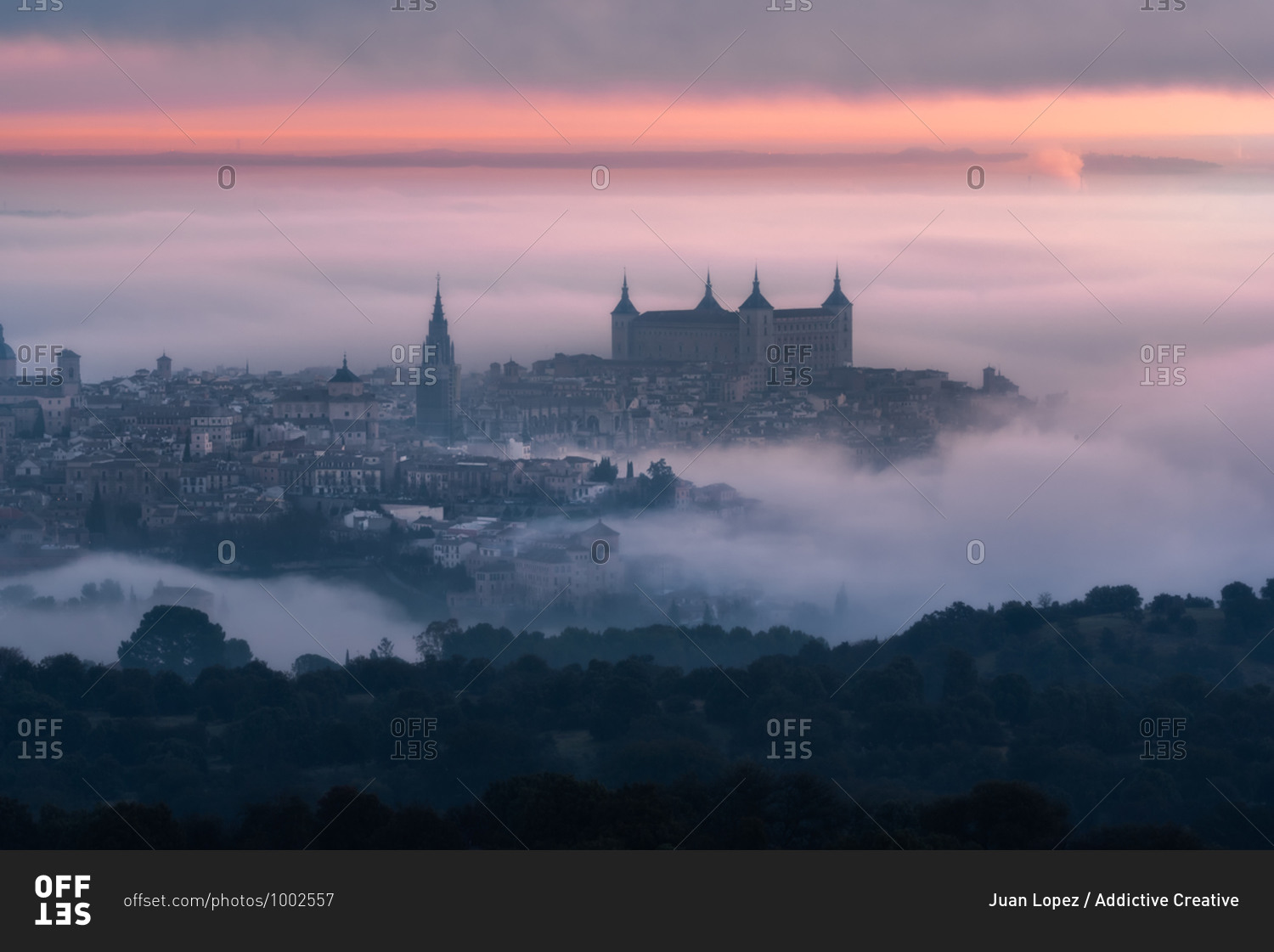 From above wonderful landscape of medieval castle built over city in misty colorful sunrise