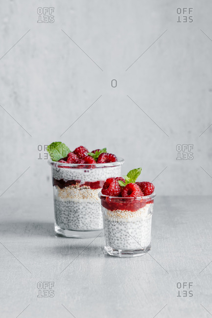 From above of glass filled with delicious pudding made with yogurt raspberries jam and chia seeds