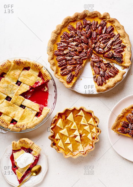 Top view shot of variety of thanksgiving pies: berry pie, pumpkin pie and pecan tart