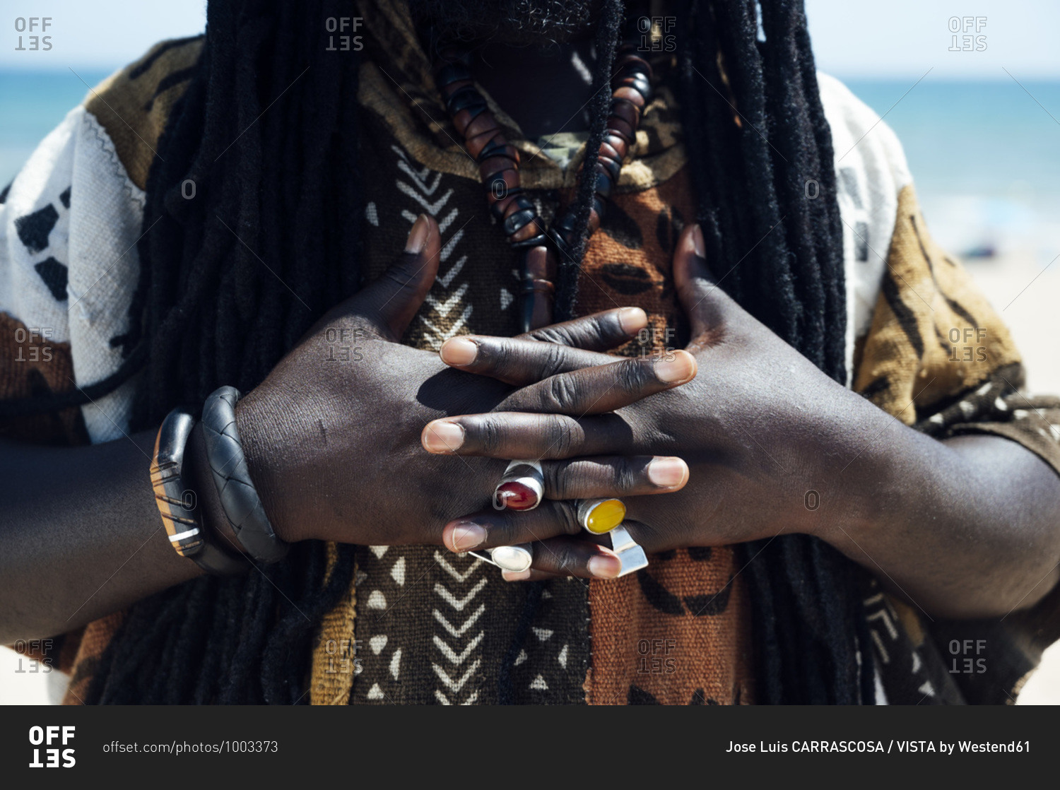 Hands with jeweled rings of man with dreadlocks