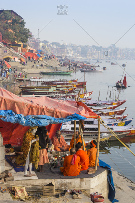 February 18, 2019: Hindu holy men on banks of Ganges River, Varanasi, Uttar Pradesh, India, Asia