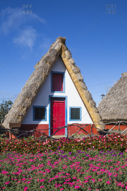 November 24, 2019: Traditional houses with steep, triangular-shaped thatched roofs, Santana, Madeira, Portugal, Atlantic, Europe
