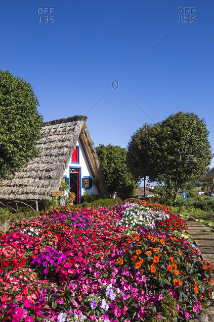 November 24, 2019: Traditional house with steep, triangular-shaped thatched roof, Santana, Madeira, Portugal, Atlantic, Europe