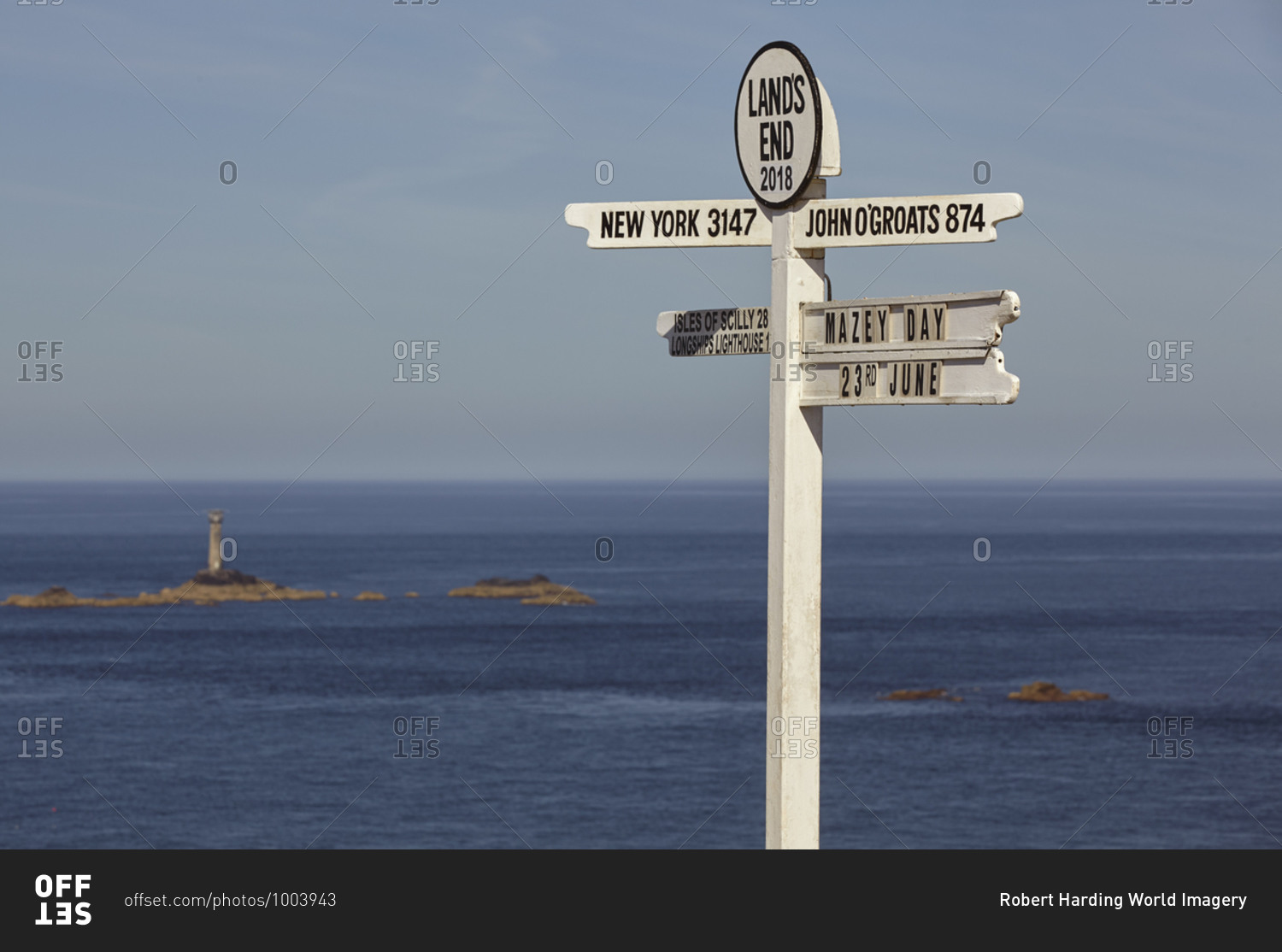 A signpost at Land\'s End, Britain\'s most southwesterly point, with Longships Lighthouse and the Atlantic Ocean behind, Cornwall, England, United Kingdom, Europe
