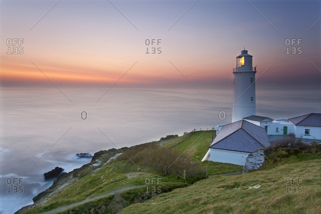 A peaceful dusk on Cornwall's Atlantic coast, showing the lighthouse at Trevose Head, near Padstow, Cornwall, England, United Kingdom, Europe