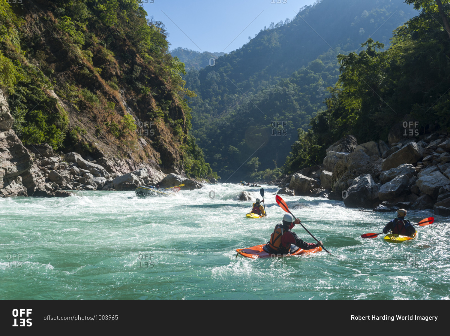 Kayakers negotiate their way through whitewater rapids on the Karnali River in west Nepal, Asia