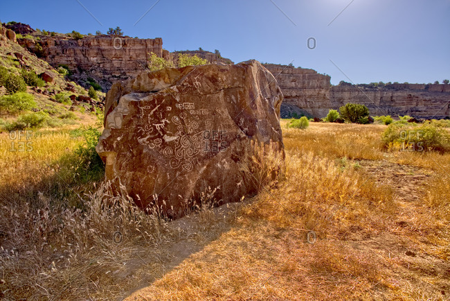 May 25, 2020: A large petroglyph covered boulder in dry Stillman Lake at the bottom of the Verde River Canyon in Paulden, Arizona, United States of America, North America