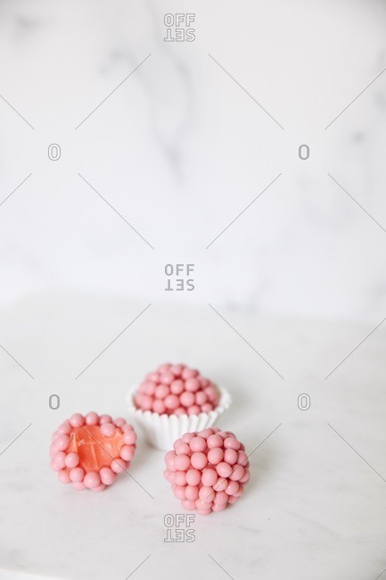 Strawberry crunchy brigadeiros on white surface