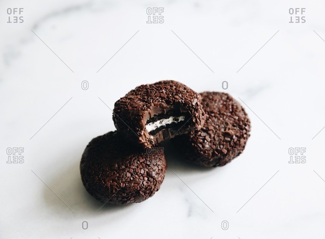 Chocolate cookie stuffed truffle cookies on white surface