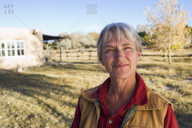 Mature woman at home on her property in a rural setting