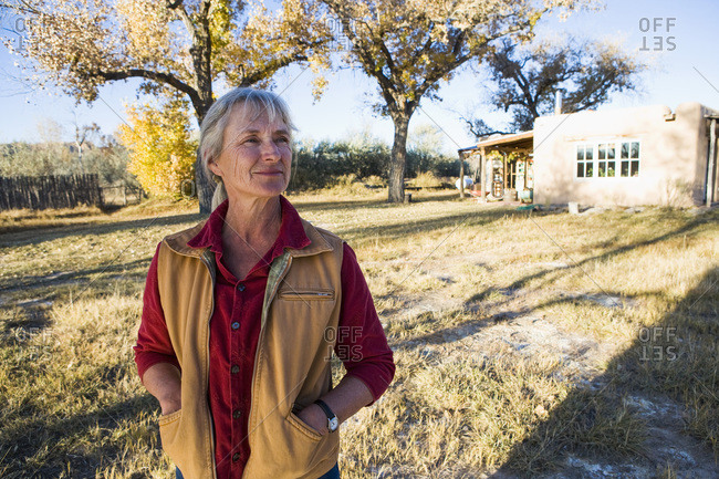 Mature woman at home on her property in a rural setting