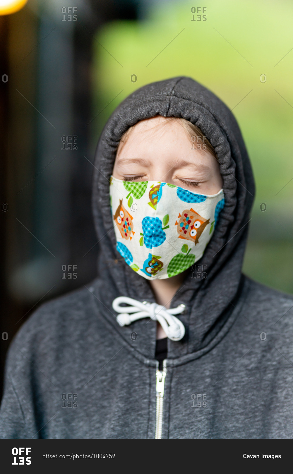 Young person wearing face mask with eyes closed during COVID pandemic