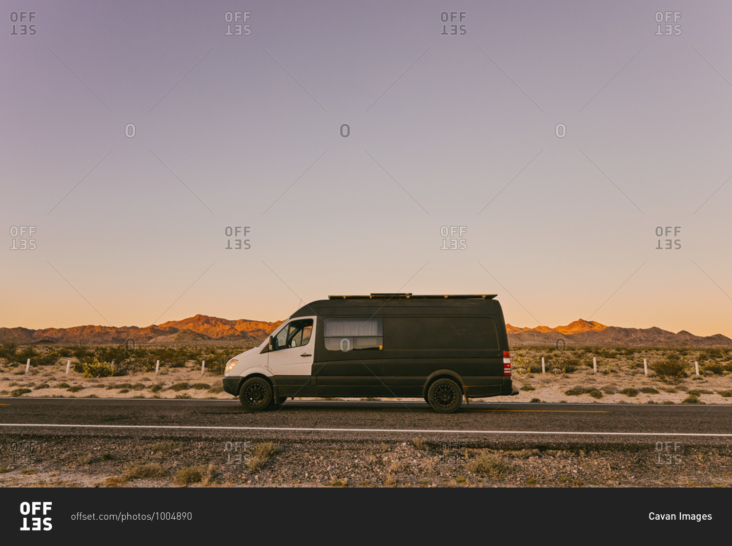 Camper van on highway during sunset in desert of Baja, Mexico.