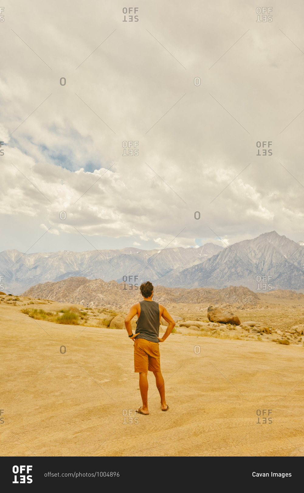 Young man in the California desert looking mountains of Alabama Hills.