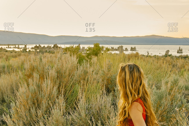 Young woman looking to Mono Lake during sunset in northern California