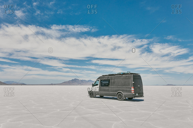 Camper van on Bonneville Salt Flats in Utah during a summer road trip.