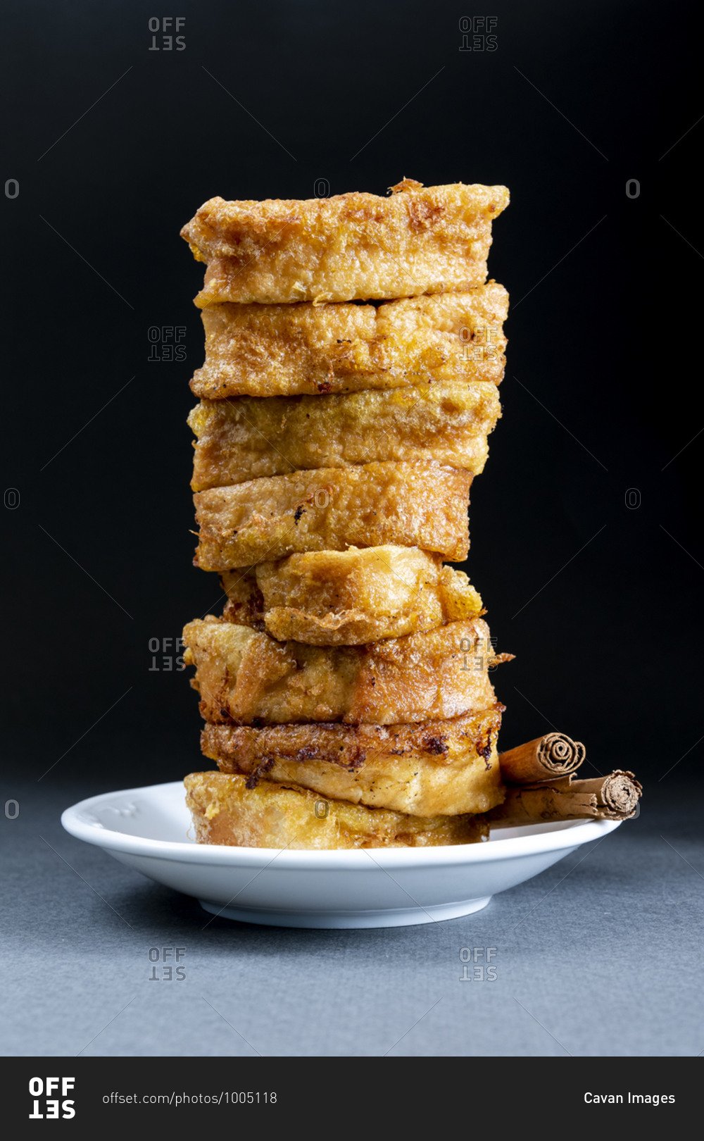 Easter dessert. Traditional homemade Spanish French toast on dark background in vertical format.