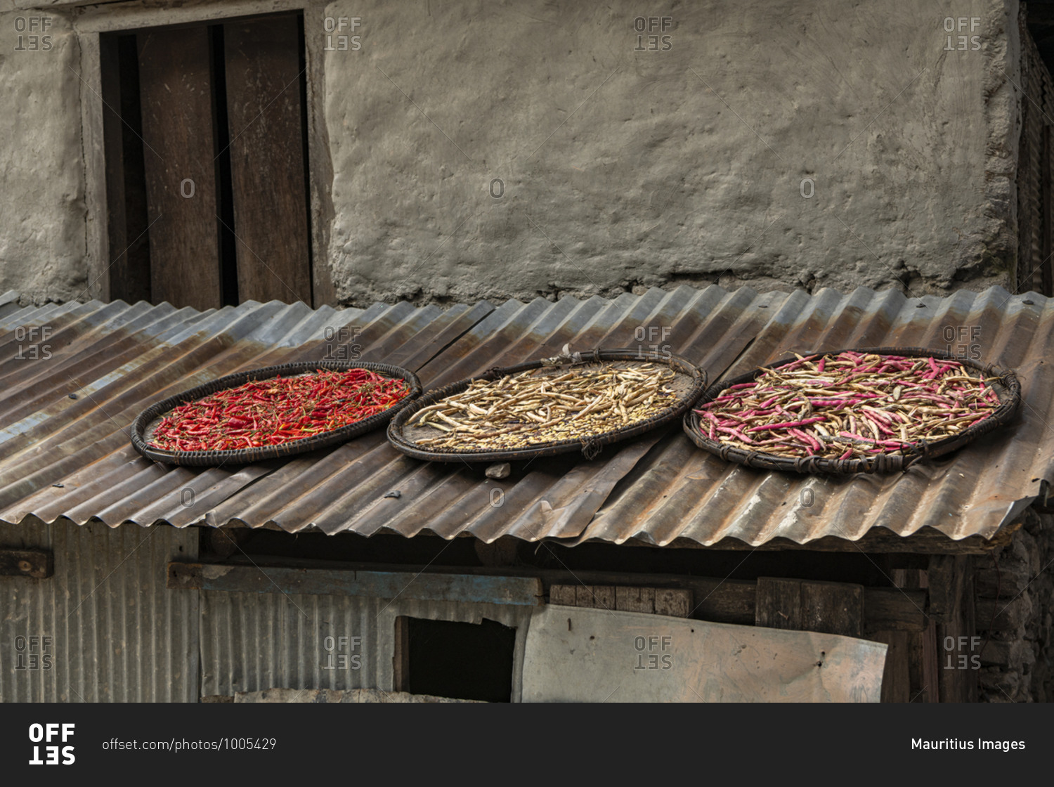 Chilli pods and beans to dry on a roof in Nepal