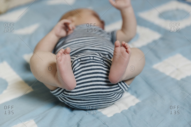 Close up a baby's feet lying on a blue blanket