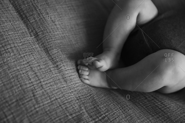 Baby's bare feet and legs in black and white