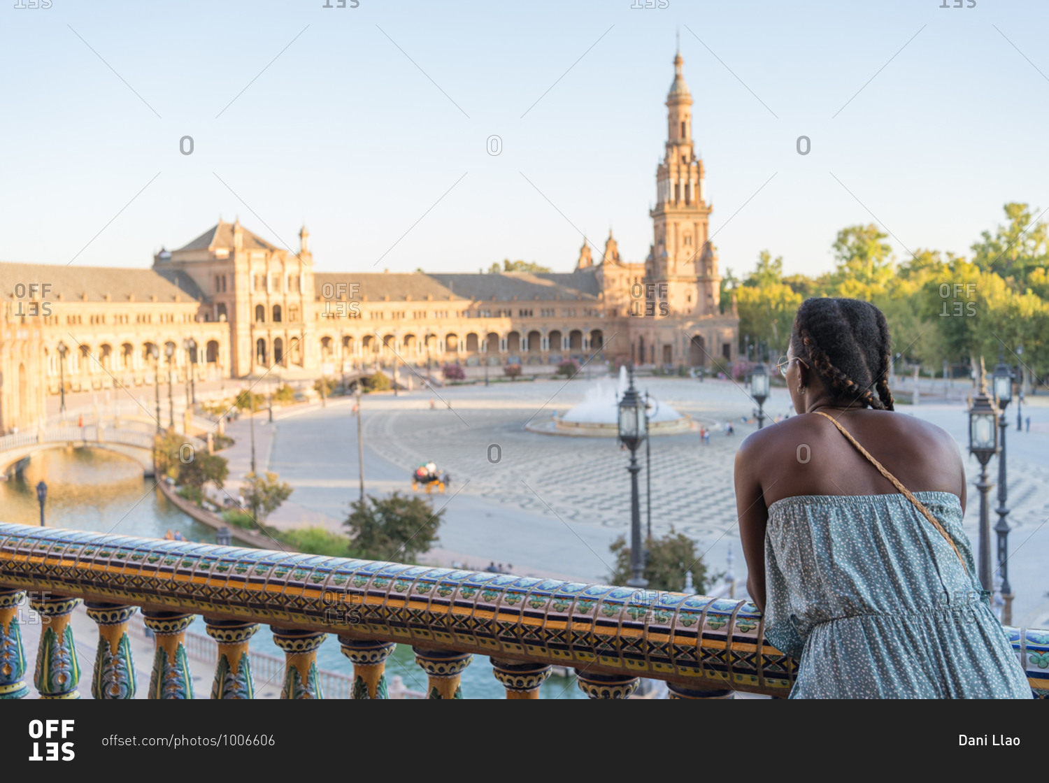 African-American woman on the balcony looking at old buildings in Seville, Spain