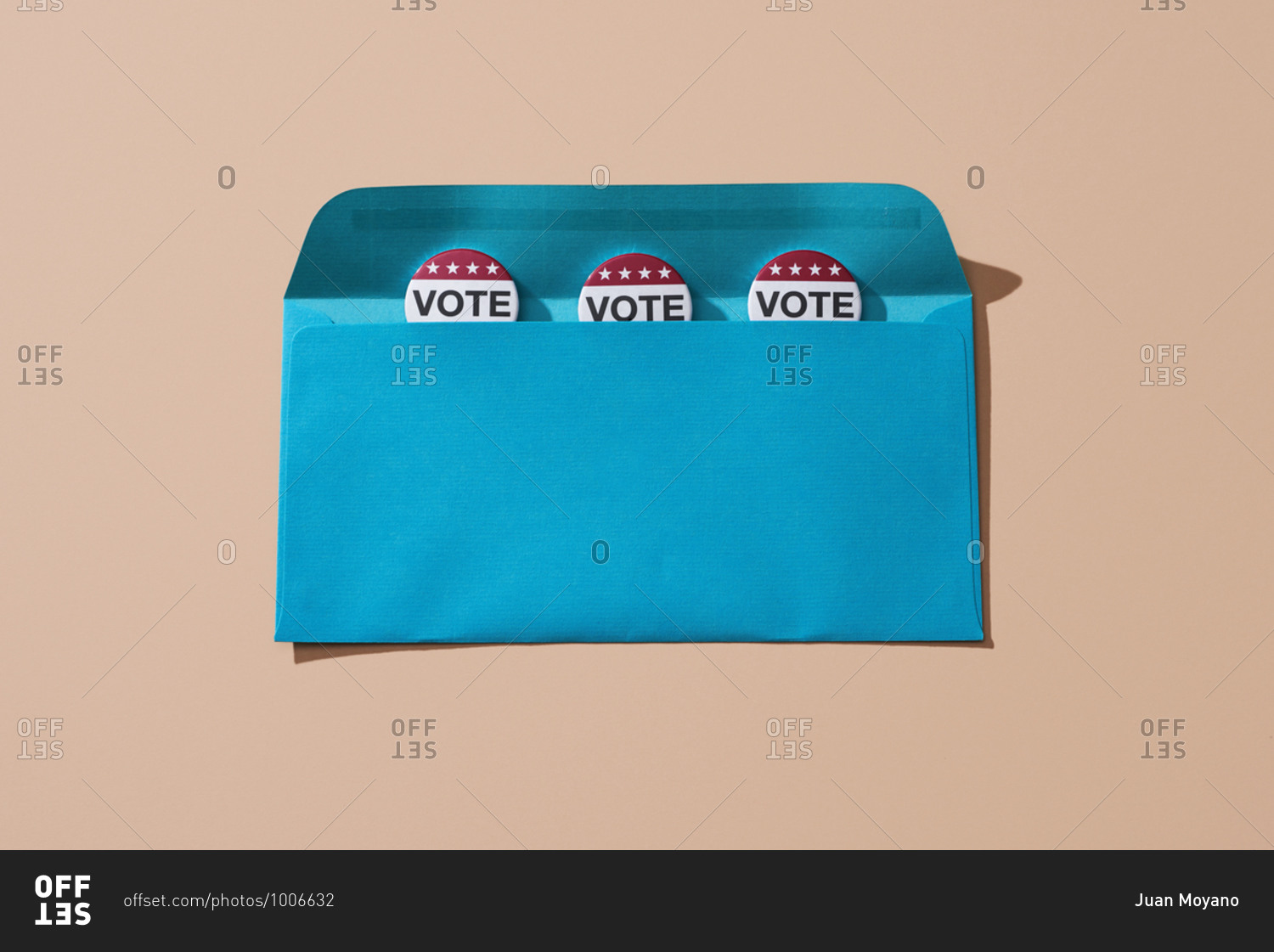 Vote badges in a blue envelope, on a salmon pink background