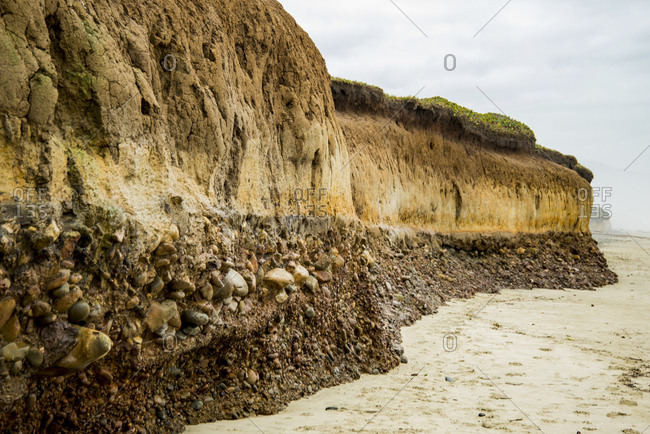 USA, Oregon. Muriel O. Ponsler Beach, bluff revealing geologic coastal layers along the beach.