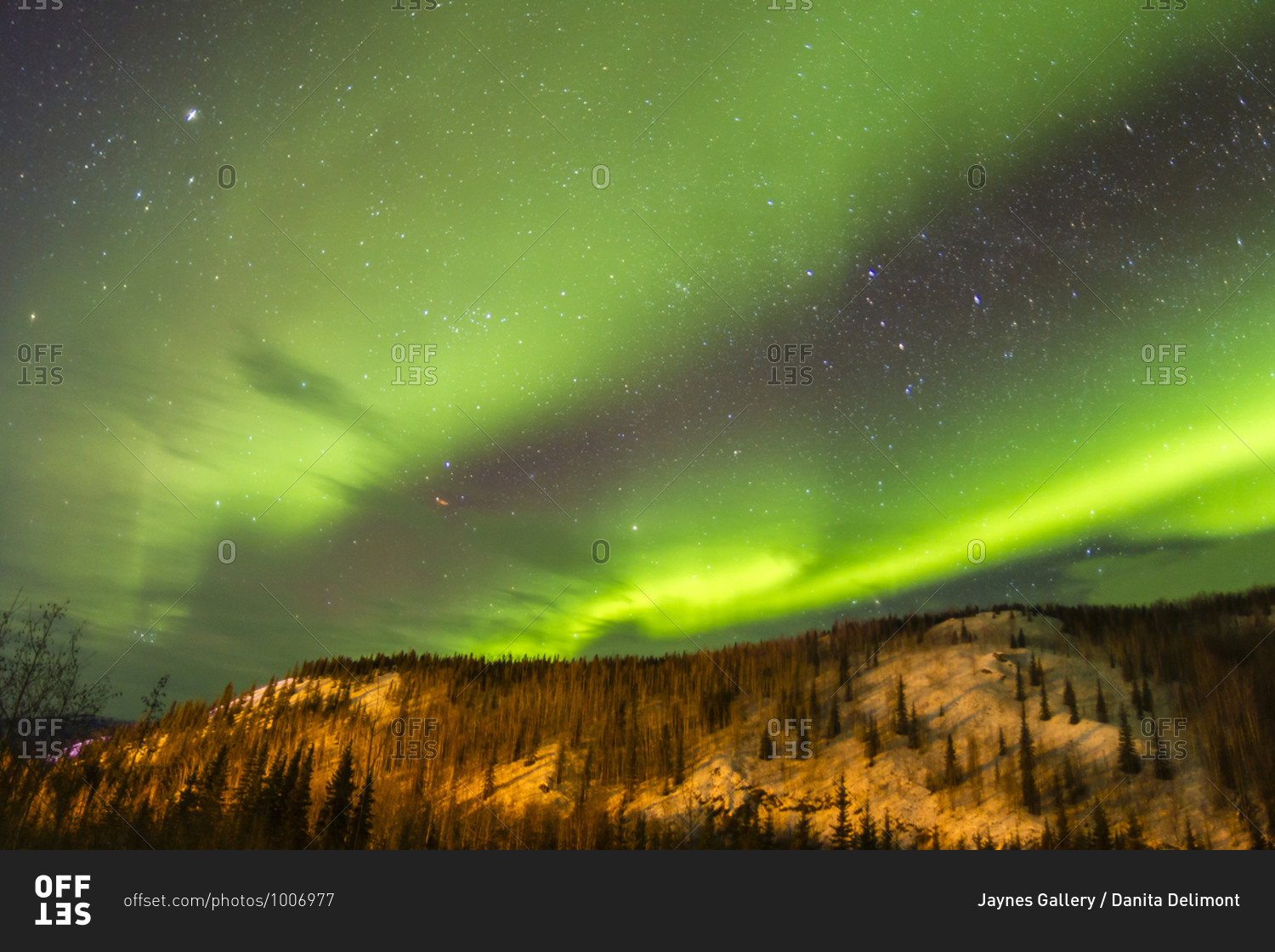 USA, Alaska, Fairbanks. Aurora borealis over mountain landscape.