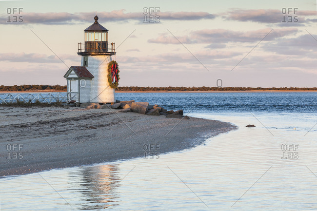 USA, Massachusetts, Nantucket Island. Nantucket Town, Brant Point Lighthouse with a Christmas wreath at dusk.