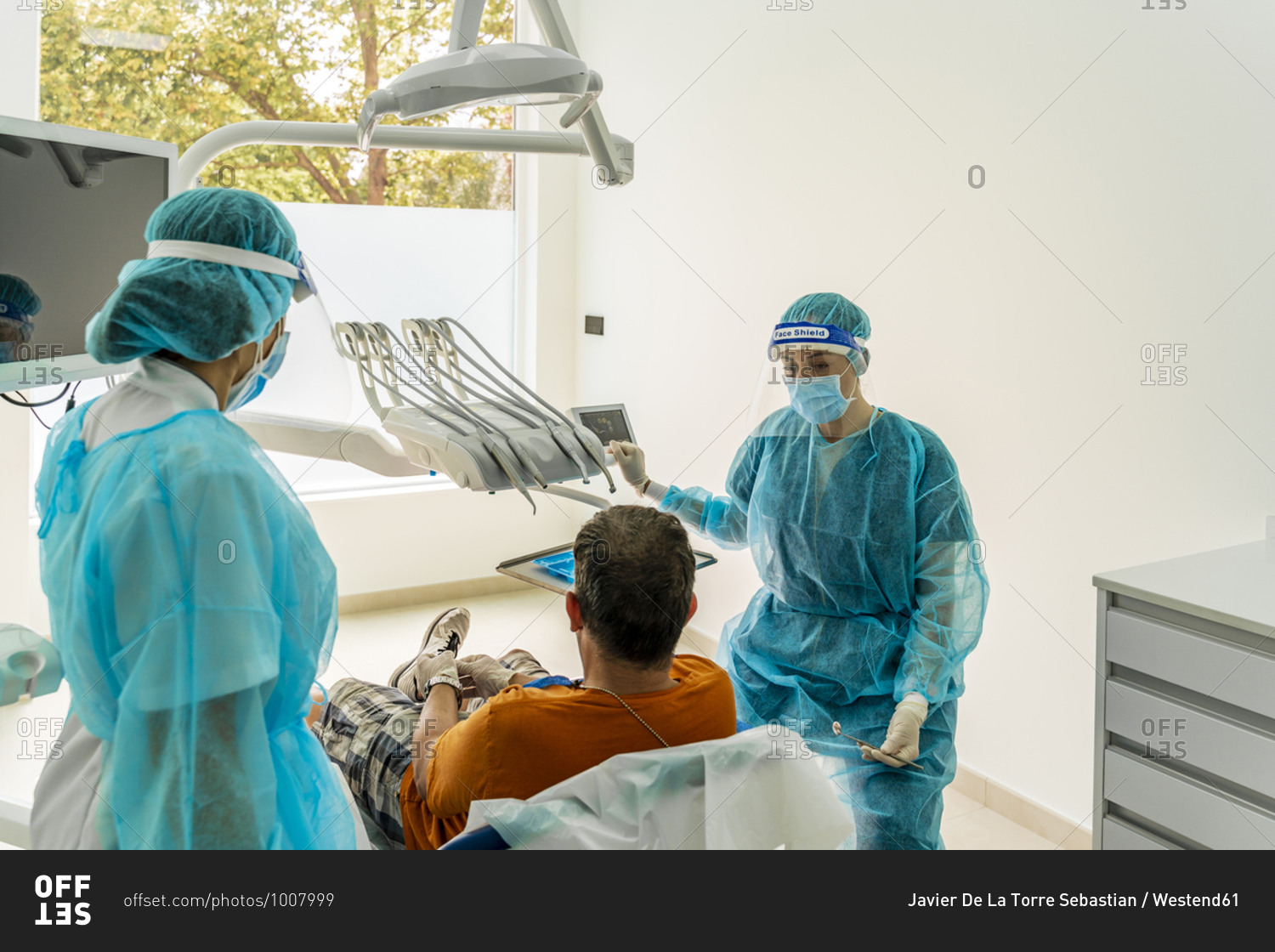 Doctor and nurse with patient in dentist's clinic