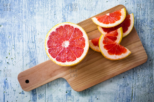Fresh grapefruit on chopping board